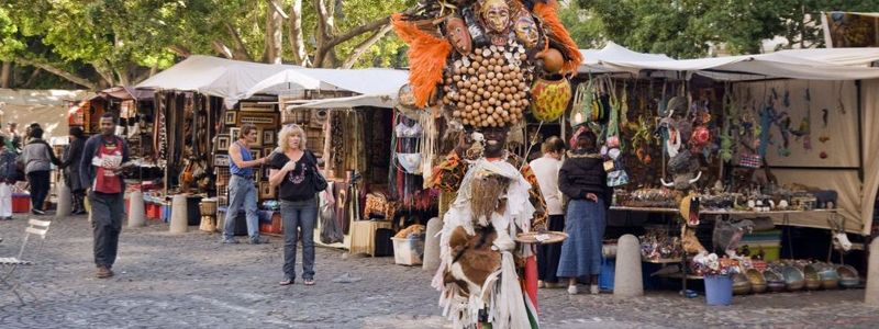 person dressed with mask and feathers on a market